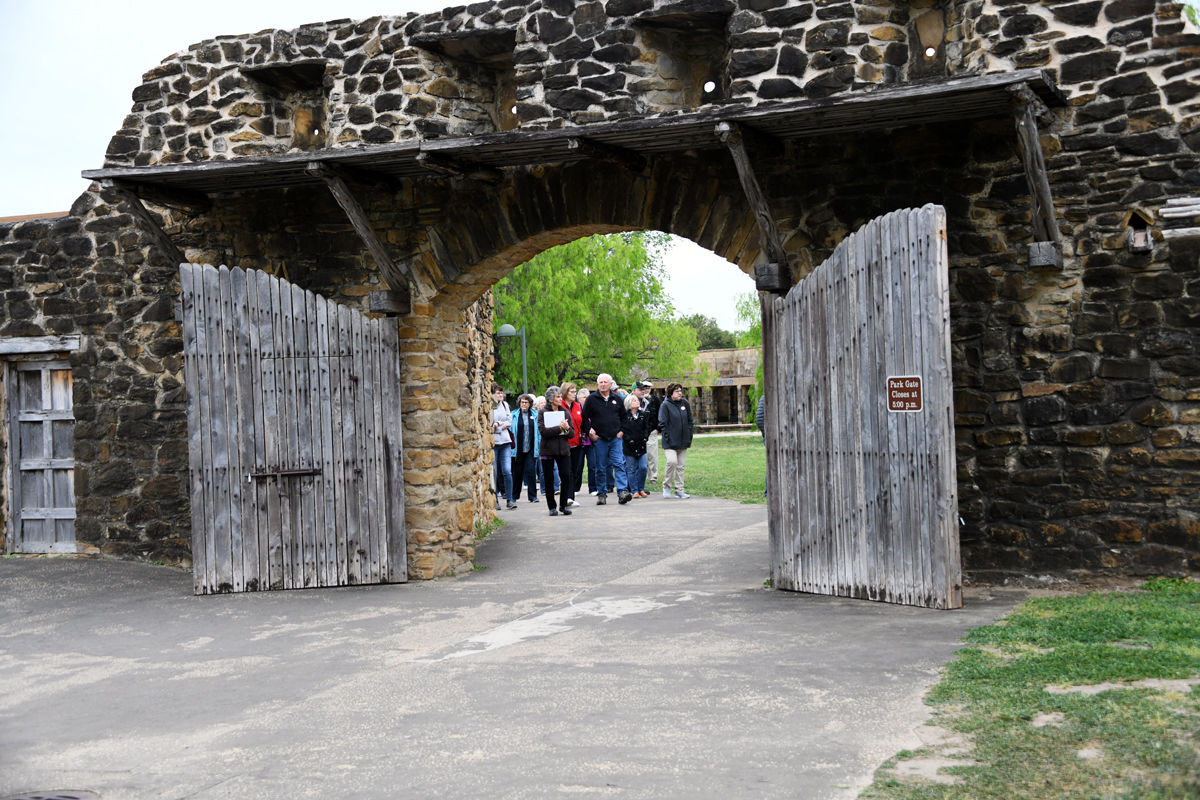 101 Fun Club travelers entering San Jose mission with tour guide Sharon Knibbe.JPG